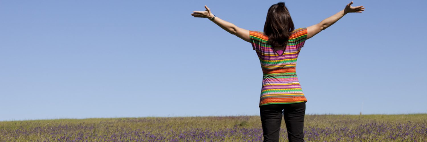 woman enjoying life in a green field